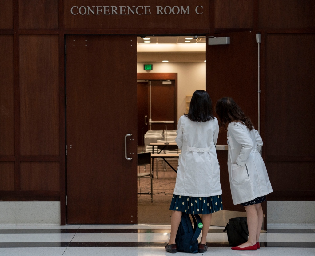Dr. Tracey Wilkinson, left, and Dr. Caroline E. Rouse, line up outside of a conference room to support Dr. Caitlin Bernard on May 25, 2023, at the Indiana Government Center in Indianapolis.