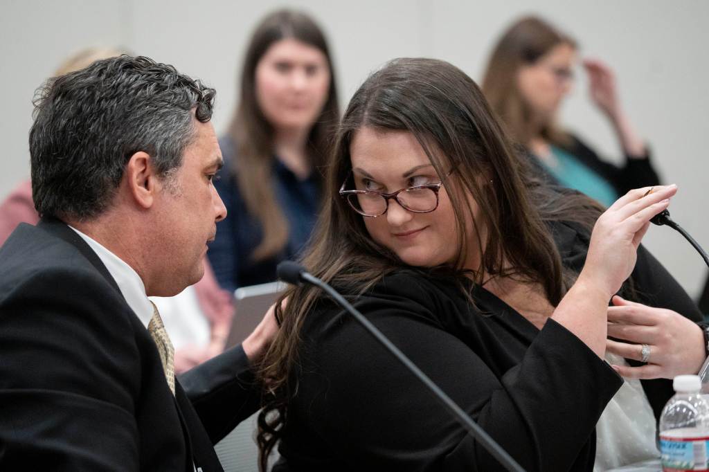 Attorneys for the state Cory Voight and Carah Rochester talk during the hearing of the state medical board on May 25, 2023, at the Indiana Government South building in Indianapolis. 