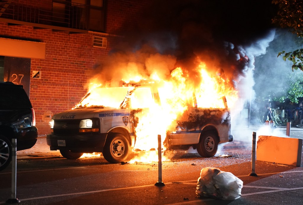 An NYPD van burns during a George Floyd protest in May of 2020. 