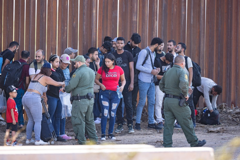 A group of migrants waiting to be processed by Customs and Border Patrol officers  at the border in Arizona on August 25, 2023.
