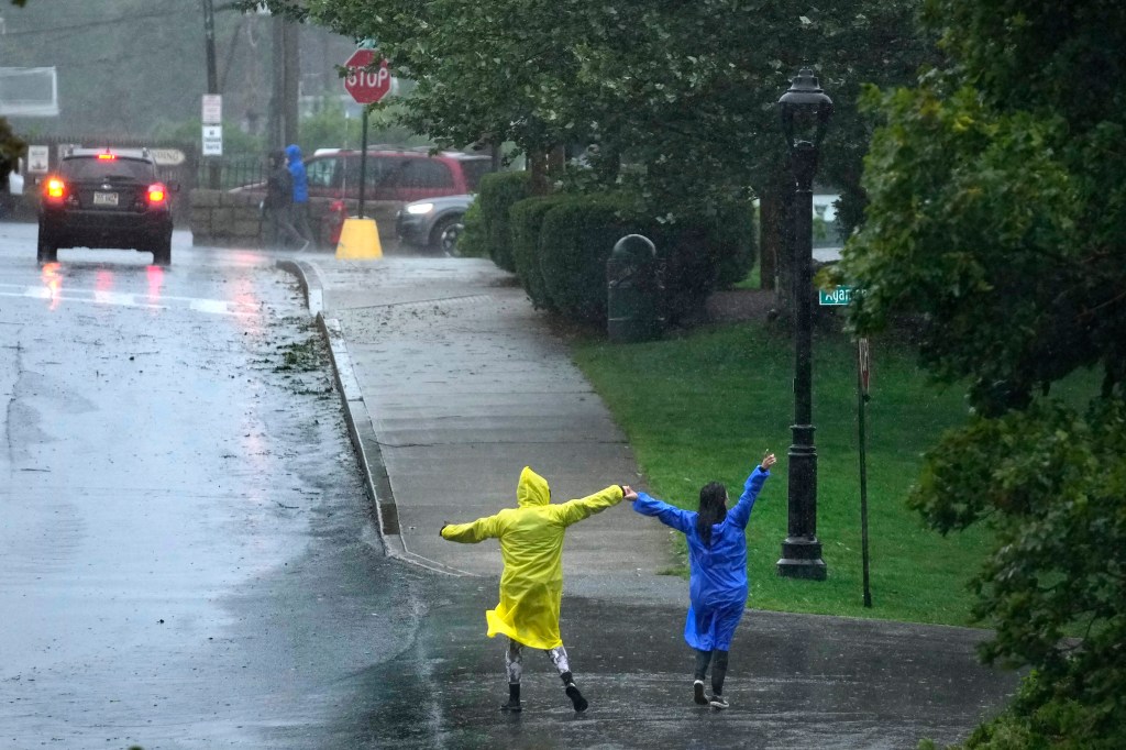 People dance in the rain during storm Lee in Bar Harbor, Maine.