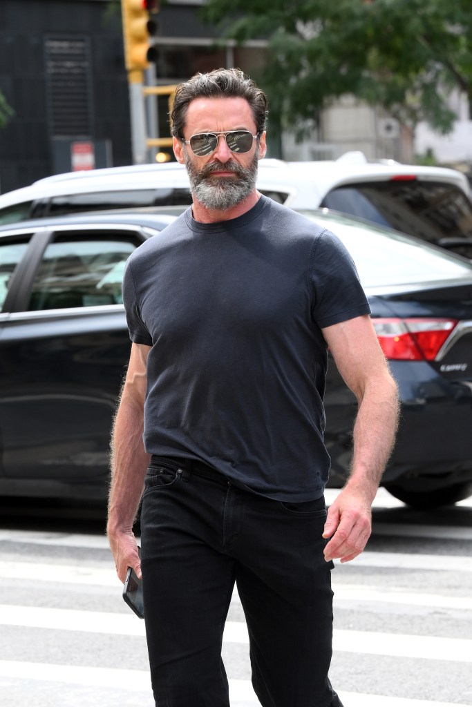 Jackman, 54, was spotted in New York City wearing a dark t-shirt that showed off the "Wolverine" star's bulging muscles as well as black pants and matching shoes. 