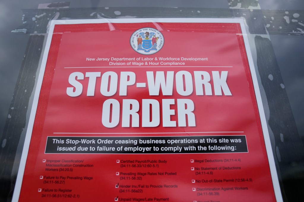 A stop work order is posted on the door of a Boston Market. 