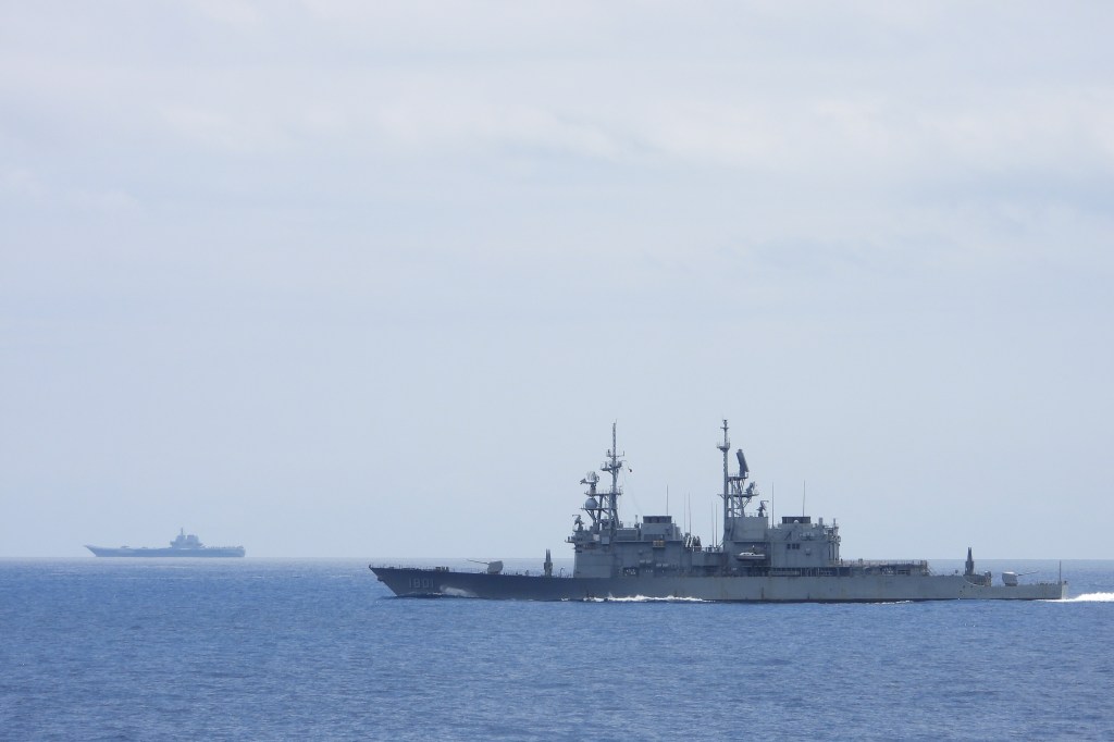 Taiwanese ship monitoring a Chinese aircraft carrier 