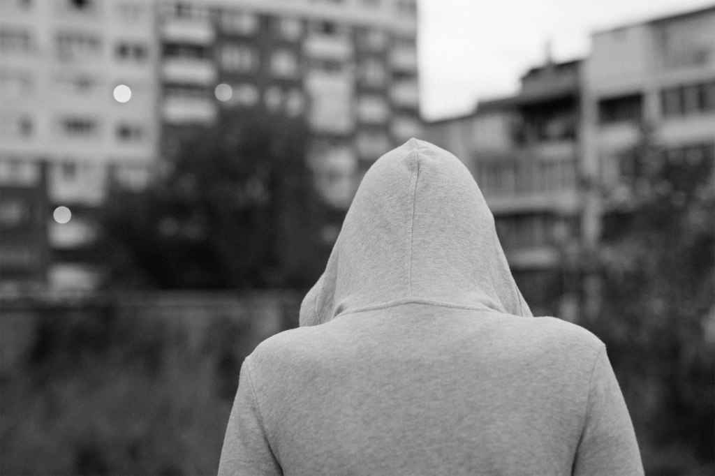 Hooded person facing away from camera