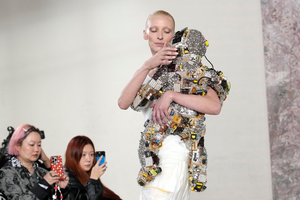 Maggie Maurer  carrying robot baby