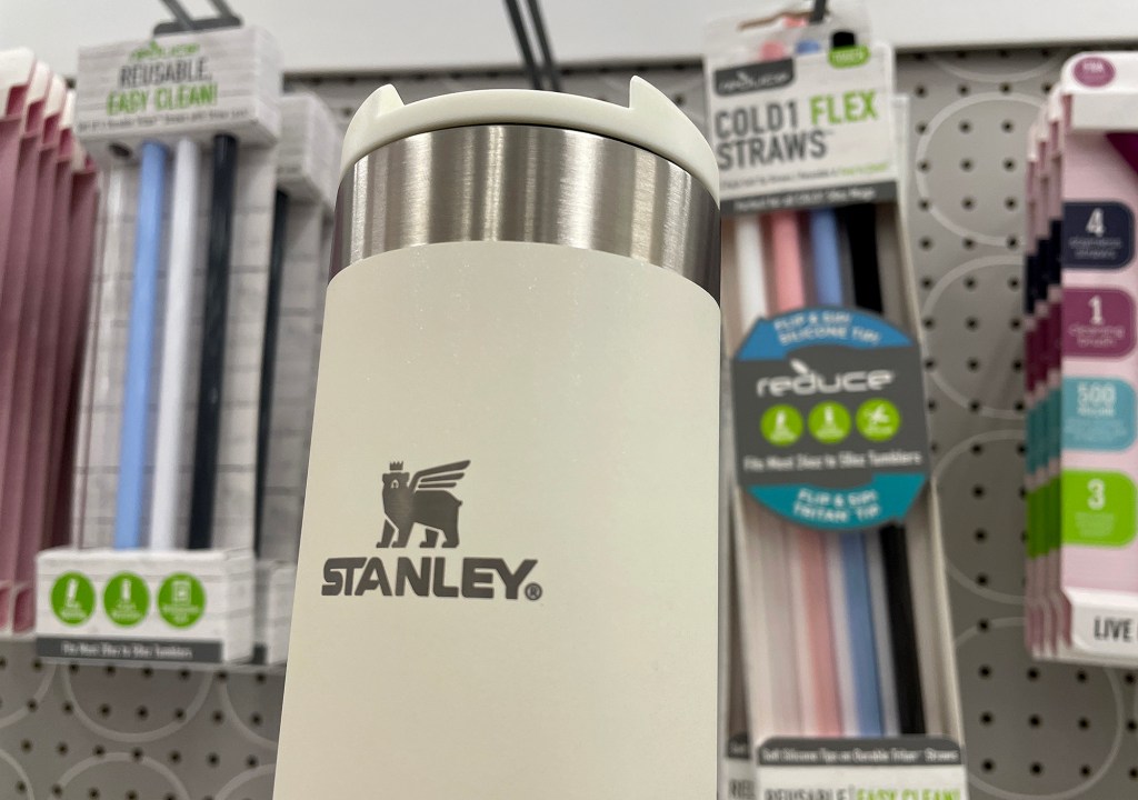 A Stanley transit bottle displayed on a shelf at Target store - white, silver and with a brand logo.