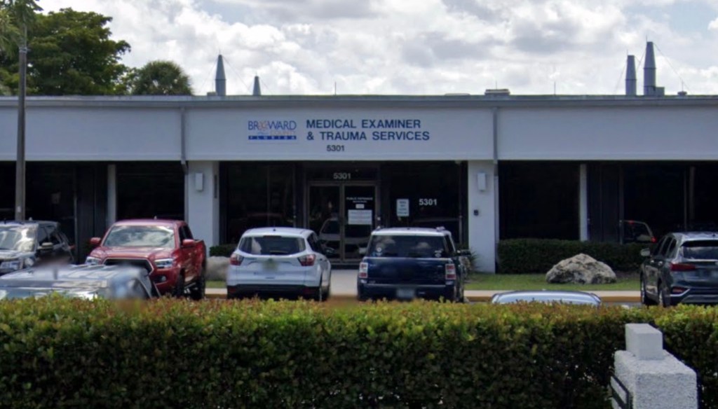 A building with parked cars in front of it located at Broward County Office of Medical Examiner and Trauma Services.