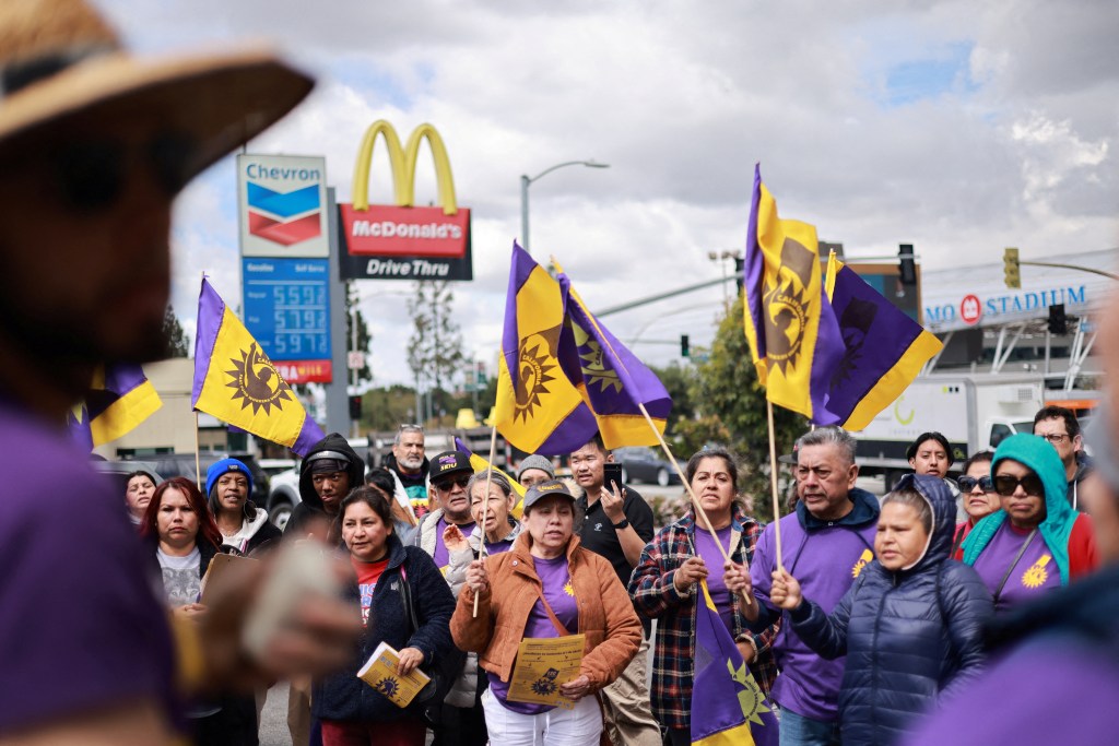 California fast food workers hold a rally as they celebrate their minimum wage increase to $20 an hour during an event in Los Angeles, California, U.S., April 5, 2024.